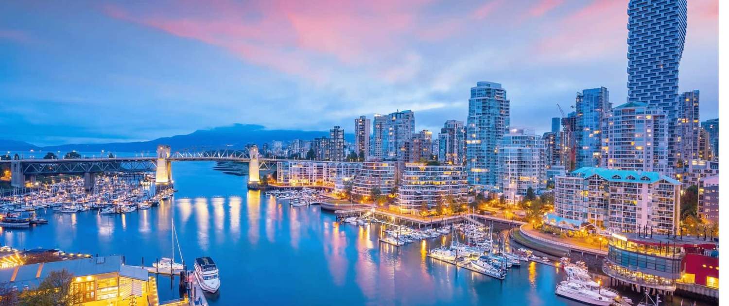 Bright Vancouver city skyline at dusk with modern high-rise buildings, marina filled with yachts, and colorful sunset sky, perfect for urban development and real estate trends.